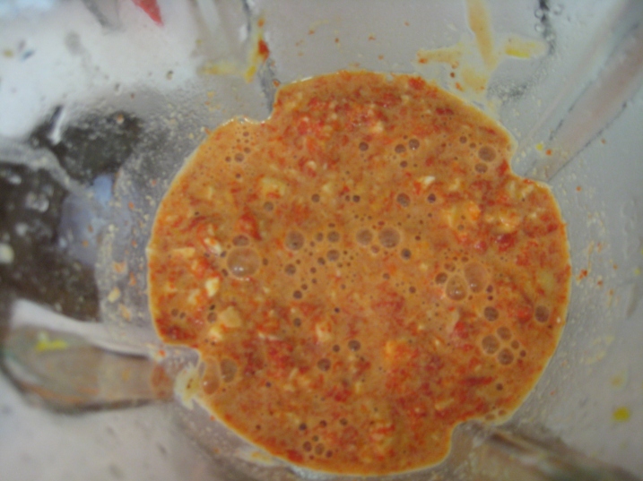 blender with cashews, tahini, roasted red pepper, nutritional yeast flakes, tamari, cayenne pepper, and water